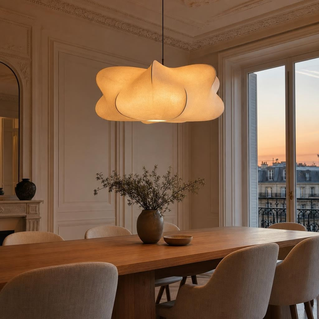 Suspension Kumo allumée au-dessus d'une table en chêne dans un appartement parisien